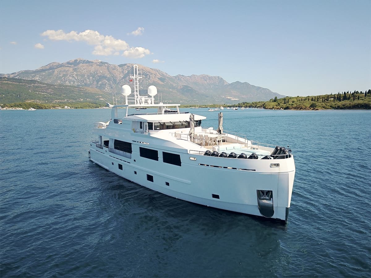 Motor Yacht Serenitas at anchor beneath the mountains of Montenegro