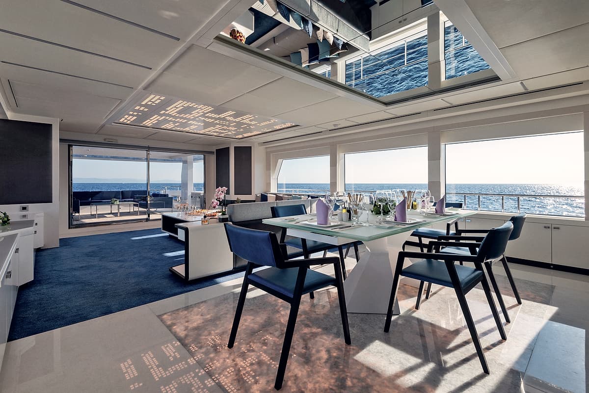 The saloon aboard Motor Yacht Serenitas, set for dinner